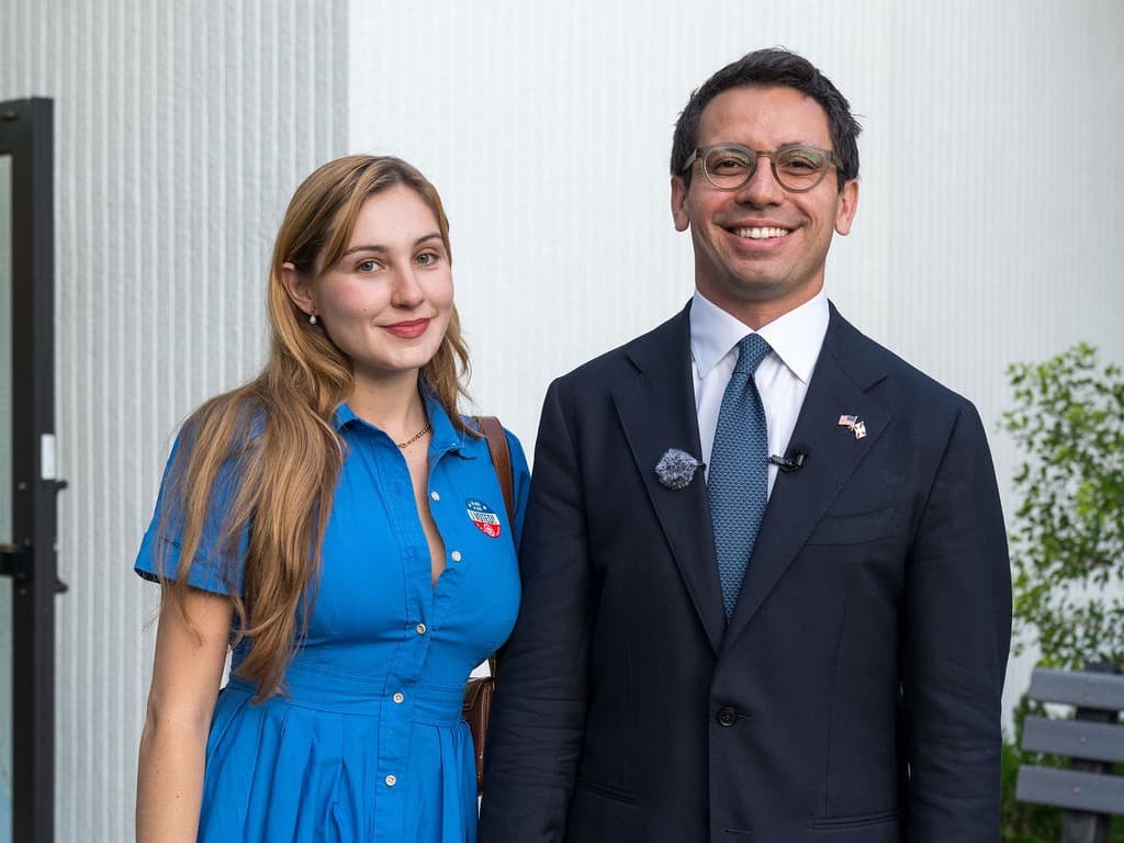 James Fishback standing outdoors with a woman wearing an I Voted sticker